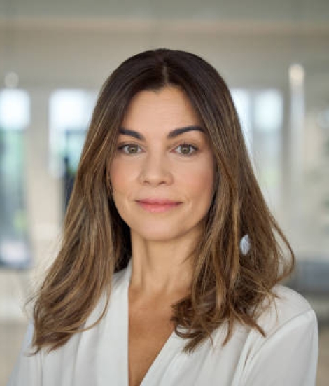 Confident smiling Latin professional mid aged elegant business woman corporate leader, happy beautiful mature female executive, lady manager standing in office looking at camera, headshot portrait.